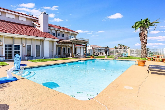 view of swimming pool featuring a pergola and a patio area