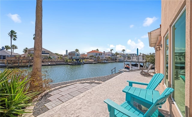 exterior space with a residential view, a water view, and a dock