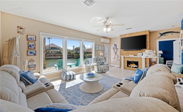 tiled living area with ceiling fan, visible vents, a fireplace, and a wall mounted AC