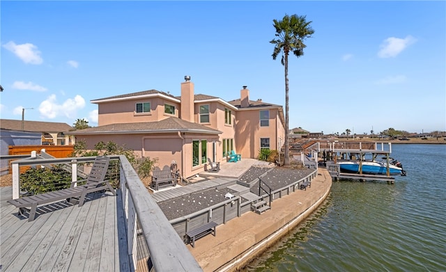 exterior space with a water view and stucco siding