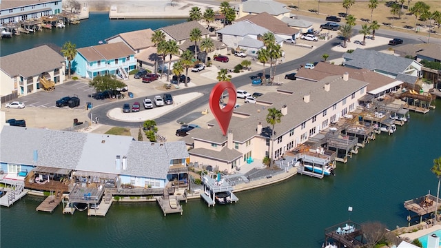 drone / aerial view featuring a water view and a residential view