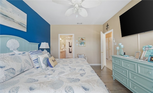 bedroom featuring connected bathroom, wood finished floors, a ceiling fan, baseboards, and visible vents