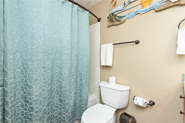 bathroom with toilet and shower / bath combo with shower curtain