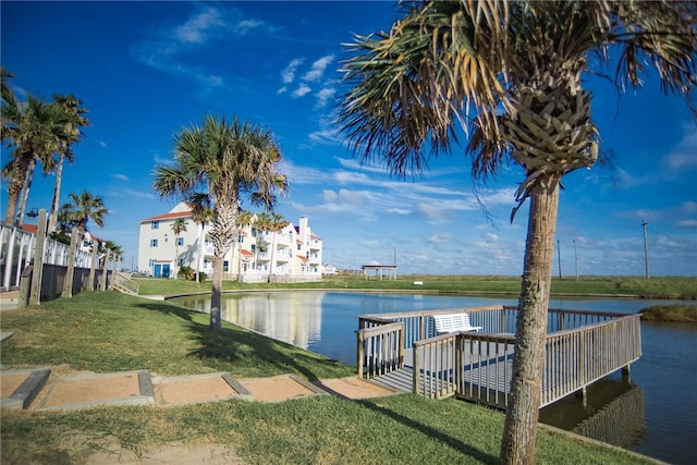 dock area with a water view and a lawn