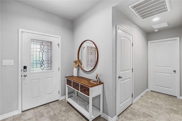 entryway with light tile patterned floors