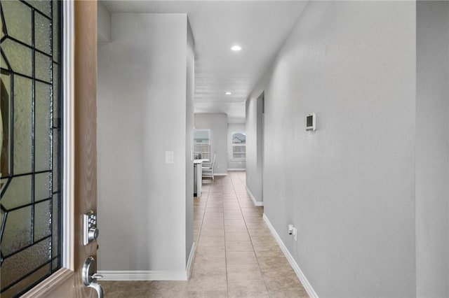 hall featuring light tile patterned floors