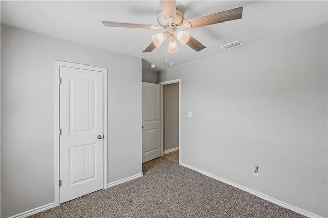 unfurnished bedroom with carpet, ceiling fan, and a closet