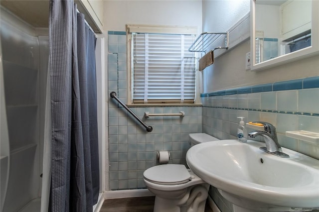 1522 Clodah Dr, Corpus Christi, TX 78404 - bathroom featuring a shower with curtain, tile walls, and wood finished floors