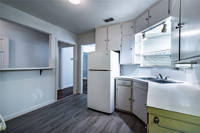 1522 Clodah Dr, Corpus Christi, TX 78404 - kitchen with freestanding refrigerator, dark wood-type flooring, and light countertops