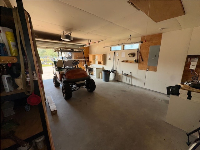 garage with electric panel and a garage door opener