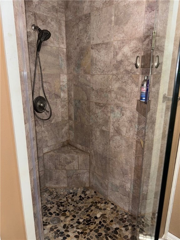 bathroom with tiled shower