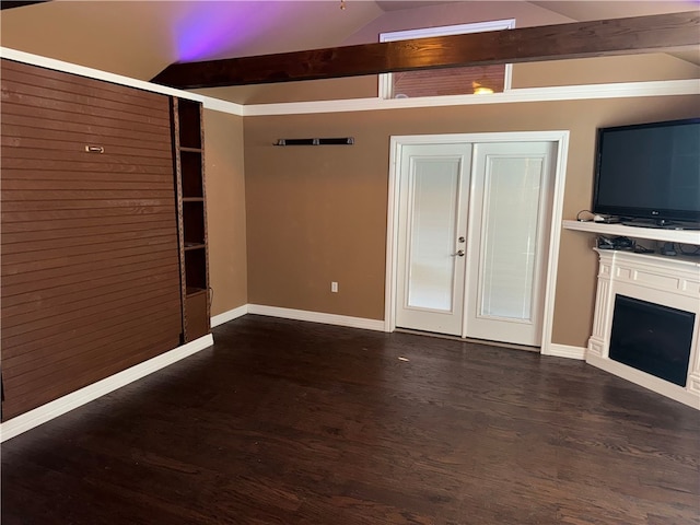 unfurnished living room featuring dark hardwood / wood-style flooring and vaulted ceiling