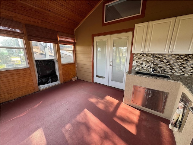 interior space featuring wooden ceiling, sink, and vaulted ceiling