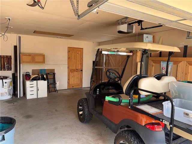 garage featuring electric water heater and a garage door opener