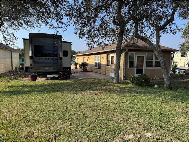 rear view of house featuring a yard