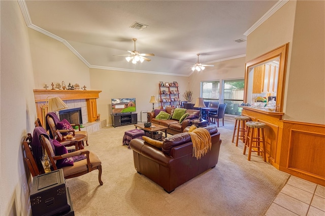 7014 Mona Lisa Cir, Corpus Christi, TX 78413 - carpeted living area with a ceiling fan, crown molding, a tiled fireplace, a wainscoted wall, and lofted ceiling