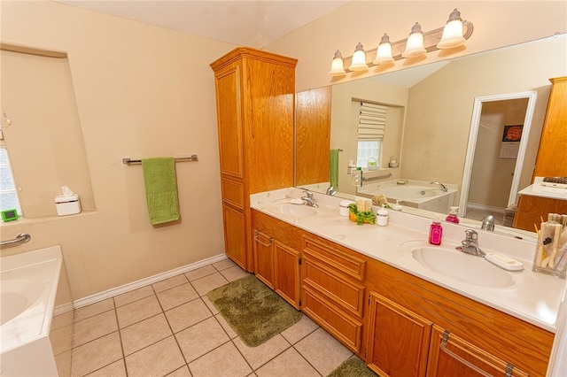 7014 Mona Lisa Cir, Corpus Christi, TX 78413 - bathroom with double vanity, a garden tub, tile patterned floors, plenty of natural light, and vaulted ceiling