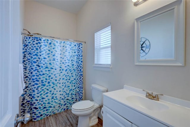 bathroom featuring a shower with curtain, vanity, hardwood / wood-style flooring, and toilet