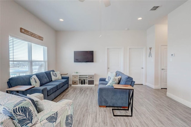 living room featuring ceiling fan and light wood-type flooring