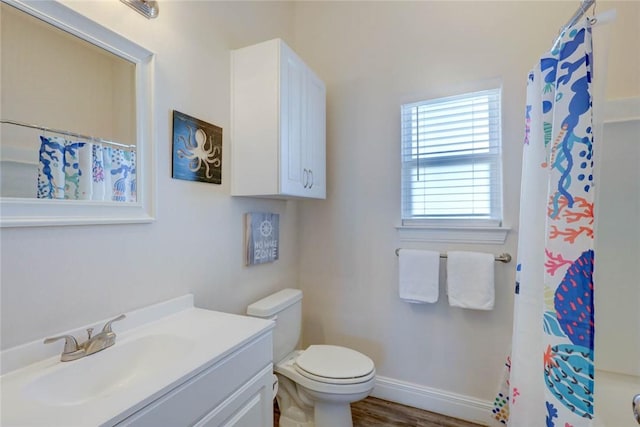 bathroom featuring walk in shower, vanity, toilet, and hardwood / wood-style floors