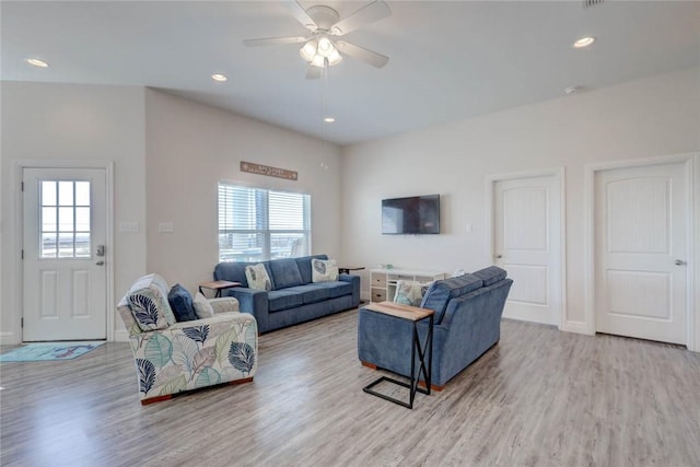 living room with a healthy amount of sunlight, ceiling fan, and light hardwood / wood-style flooring