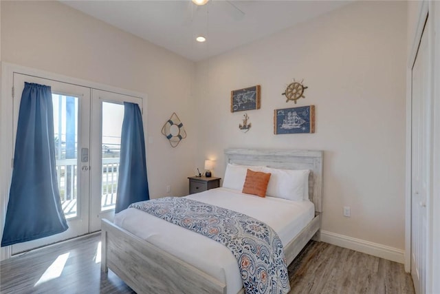 bedroom with a closet, light hardwood / wood-style flooring, access to exterior, ceiling fan, and french doors