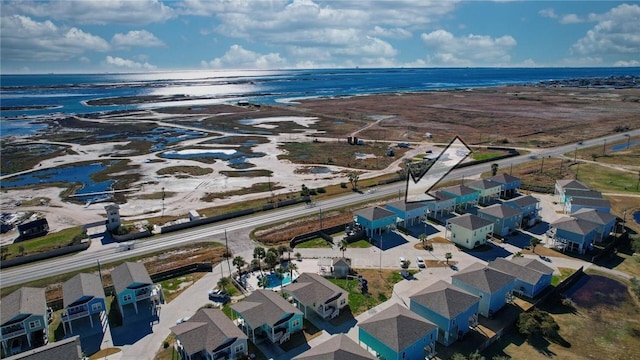 drone / aerial view with a water view and a view of the beach