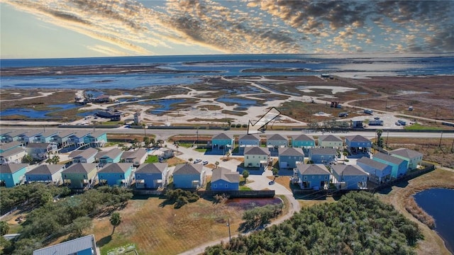 aerial view at dusk with a water view