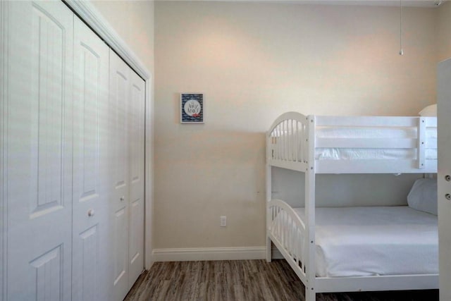 bedroom with hardwood / wood-style flooring and a closet