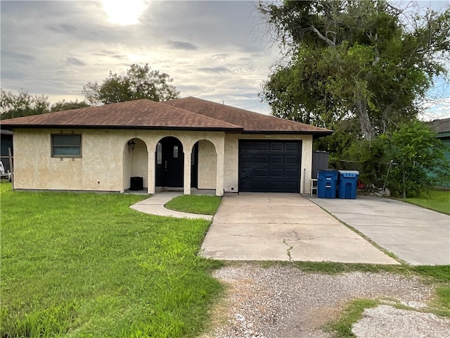 view of front of house with a garage and a front lawn