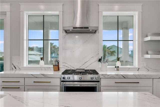969 Banyan Beach Dr, Port Aransas, TX 78373 - kitchen featuring wall chimney exhaust hood, high end stainless steel range, and white cabinetry