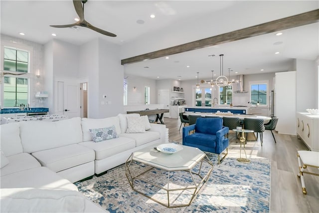 969 Banyan Beach Dr, Port Aransas, TX 78373 - living area with a ceiling fan, beam ceiling, light wood-style floors, recessed lighting, and a chandelier