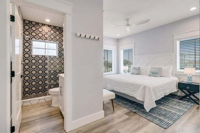 969 Banyan Beach Dr, Port Aransas, TX 78373 - bedroom featuring light wood-style flooring, ensuite bathroom, a ceiling fan, and baseboards