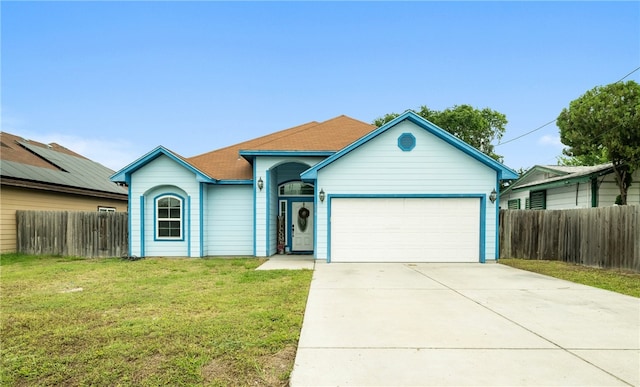 single story home featuring a garage and a front lawn