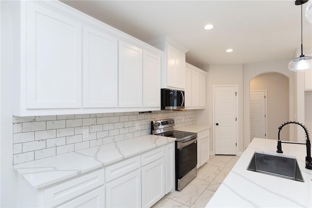 7905 Spiderman Dr, Corpus Christi, TX 78414 - kitchen with a sink, stainless steel electric stove, marble finish floor, recessed lighting, and arched walkways