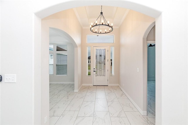 7905 Spiderman Dr, Corpus Christi, TX 78414 - foyer with baseboards, marble finish floor, ornamental molding, a chandelier, and arched walkways