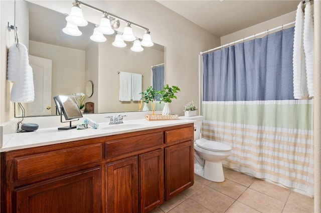 bathroom with vanity, toilet, and tile patterned floors