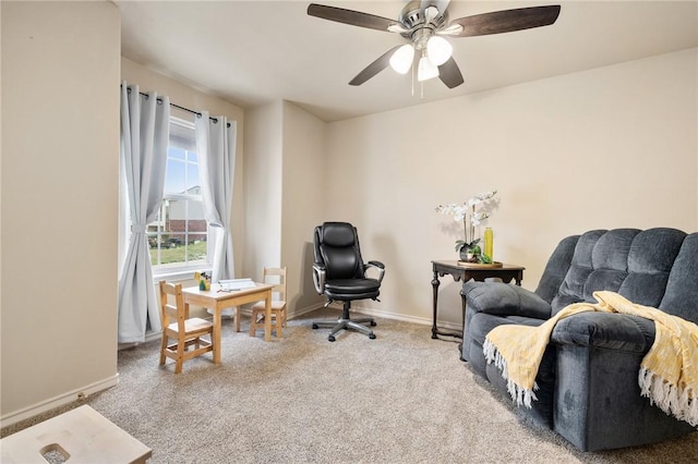 sitting room featuring carpet floors and baseboards