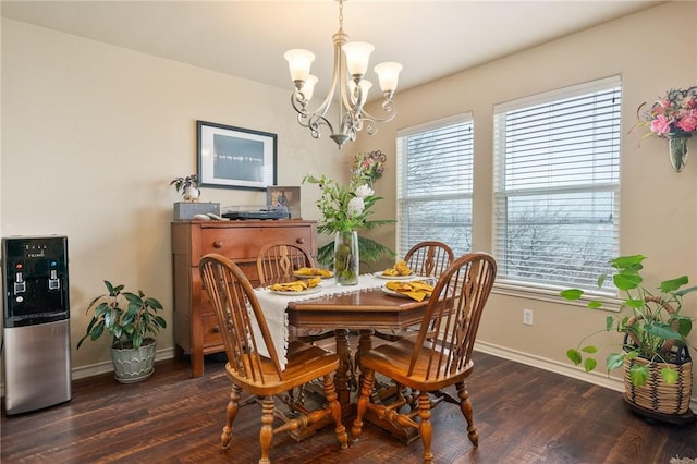 dining space with dark wood-style floors, baseboards, and an inviting chandelier