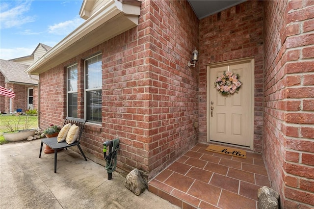 doorway to property with brick siding