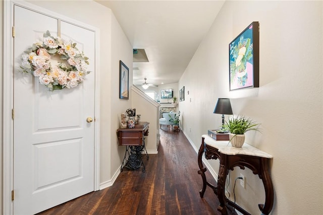 hallway with baseboards and wood finished floors