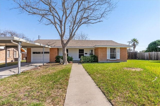 single story home featuring driveway, brick siding, a front yard, and fence