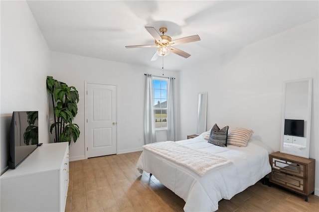 bedroom with light hardwood / wood-style flooring and ceiling fan