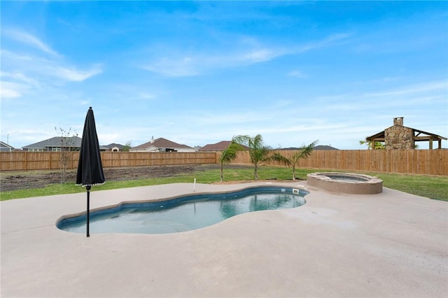 view of swimming pool featuring a lawn and an in ground hot tub