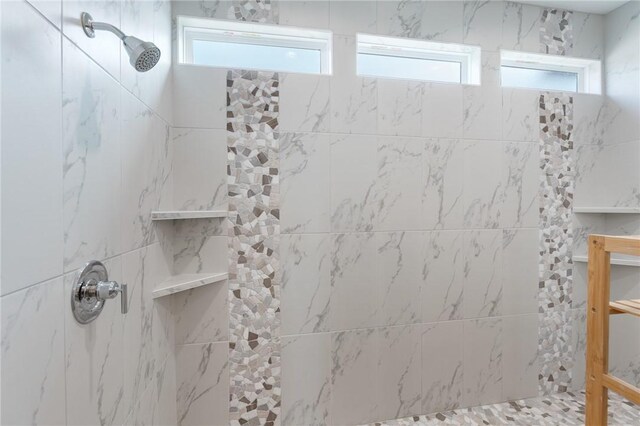 bathroom featuring a tile shower