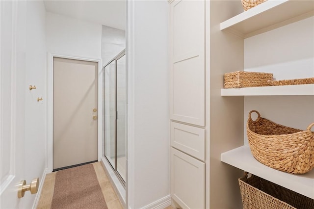 bathroom with tile patterned floors and a shower with shower door