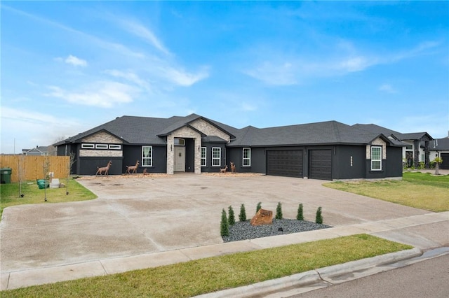 view of front of house with a front yard and a garage