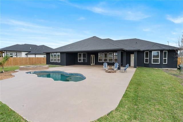 view of swimming pool with a patio area, an in ground hot tub, a yard, and an outdoor fire pit