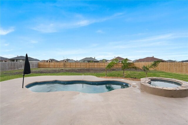 view of swimming pool featuring an in ground hot tub and a lawn