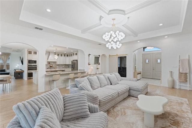 living room featuring beamed ceiling, an inviting chandelier, light hardwood / wood-style flooring, and crown molding